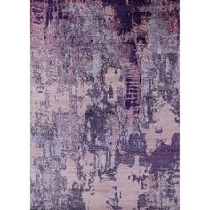 an area rug with various colors and patterns on the carpet, including purples and browns