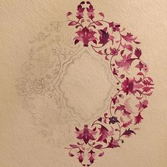 a drawing of a circle with pink flowers on it's side and an intricate design in the middle