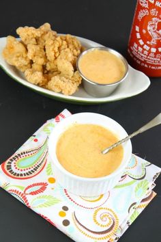 two plates filled with food and dipping sauce