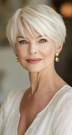 Attention silver beauties! Explore 34 chic short haircuts designed specifically for women over 60. These flattering styles will enhance your natural beauty and take years off your appearance. From textured crops to sophisticated bobs, find the perfect low-maintenance cut that suits your lifestyle and personality. Embrace your age with confidence and style! Short Bob Hairstyles Women Over 50, Low Maintenance Pixie Bob Haircut, Back View Short Haircuts, Short Hair For 80 Year Old Women, Short Hairstyle Women 60 Years Old, Short Bob Cuts For Women, Short Hair For 60 Year Old Women, Haircut For Short Hair For Women, Wedge Haircut For Women Over 50