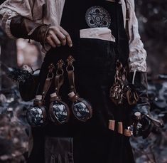 a man wearing an apron and holding several pairs of scissors