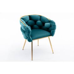 a blue velvet chair with gold legs and an upholstered cushion on the back