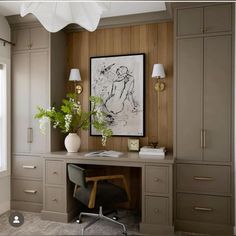 a desk with a chair, lamp and painting on the wall in a home office