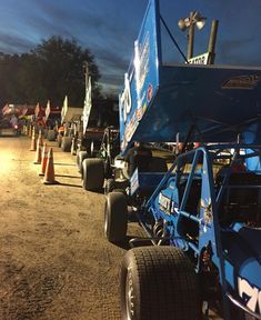 some dirt cars are lined up in the dirt