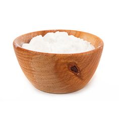 a wooden bowl filled with white sugar