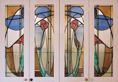 three stained glass doors with flowers on them