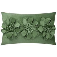 a green pillow with three flowers on the front and one flower on the back,