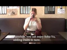 a woman sitting at a table with food in front of her and the words mean while you can enjoy soba - yu, adding dash to taste