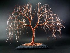 a sculpture of a tree with no leaves on it's branches is shown in front of a black background