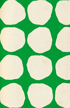 a green background with white circles on the bottom and one circle in the middle that has been cut out