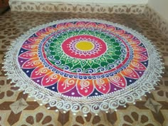 a colorful circular design is on the floor