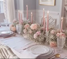 the table is set with flowers and candles