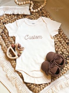 Party Crown Crafts offers premium embroidered bodysuits that are perfect for pregnancy announcements, birth announcements, hospital bring-home outfits, photo props, flat-lays, and personalized baby shower gifts and more. Bodysuits are supplied through Gerber-- ONESIES® Brand trademark is owned by Gerber Childrenswear LLC - Gerber Brand Premium 100% cotton interlock fabric, extremely soft, warmer than cotton rib, and holds the perfect amount of stretch - Certified with STANDARD 100 by OEKO-TEX® so that you don't have to worry about harmful substances in your baby's clothing - Short Sleeves and Long-Sleeves - Designed for easy changes with expandable lap shoulder necklines & two high-positioned bottom snaps. - 2 Colors available: White and Cream - 4 Sizes available: 0-3 months, 3-6 months, 6 Personalized Baby Shower Gifts, Crown Crafts, Pregnancy Announcements, Personalized Baby Girl, Flat Lays, Personalized Baby Shower, Girl Onesies, Gender Neutral Baby Clothes