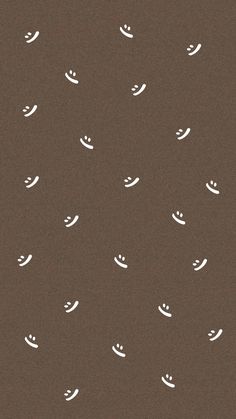 a brown background with white smiley faces on it