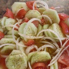 sliced tomatoes, onions and cucumbers are mixed together in a bowl to make a salad