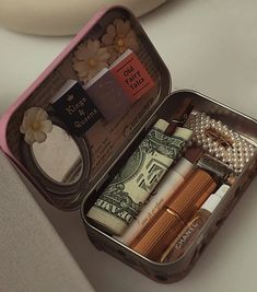 an open tin with some items in it