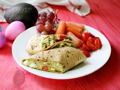 an egg, carrots, and other food items are on a plate next to some eggs