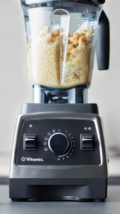 a blender filled with food sitting on top of a counter