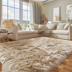 a living room filled with furniture and a large rug on top of a hard wood floor