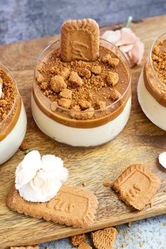 three desserts are arranged on a wooden board