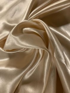 a close up view of a white satin fabric