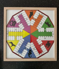 a colorful board game in a wooden frame