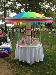 a colorful carousel sits in the middle of a park