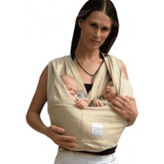 a woman is holding a baby in a sling that's attached to her chest