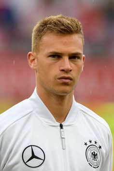 a soccer player is standing in front of the camera with his head turned to the side