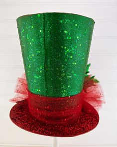 a green and red top hat with sequins on it