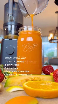 an orange juice is being poured into a jar