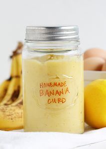 a jar filled with food next to bananas and eggs