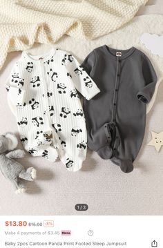 two baby sleepsuits are on the floor next to a stuffed animal