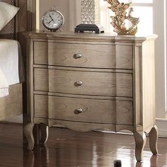 a bedroom scene with focus on the dresser and clock