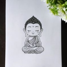 a drawing of a buddha sitting on top of a piece of paper next to a potted plant