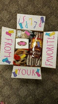 a box filled with lots of treats on top of a carpet