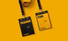 two black and yellow tags with lanyards attached to them on a yellow background