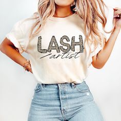 a woman in jeans and a t - shirt with the word lashes written on it