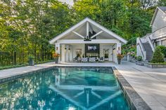 a house with a swimming pool in the middle and stairs leading up to it's entrance