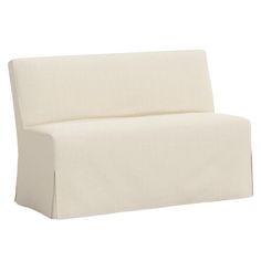 a white couch sitting on top of a white floor