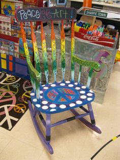 a child's rocking chair made out of crayons with peace sign on it