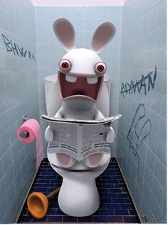 a toilet with a newspaper in the shape of a rabbit