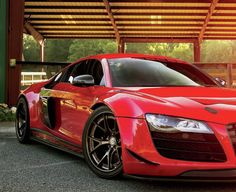 a red sports car parked in front of a building