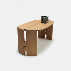 a wooden table with a metal object on it's top and bottom part in the shape of an elephant