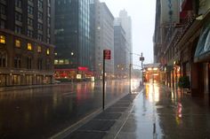 an empty city street in the rain at night