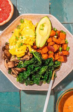 a plate with vegetables, eggs and other foods on it next to a bowl of soup