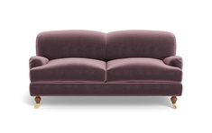 a purple couch sitting on top of a white floor