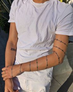 a man with barbed wire on his arm