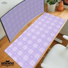 a computer desk with a purple checkered pattern on the top and bottom surface, next to a potted plant