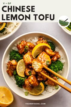 a bowl filled with chicken, broccoli and lemons next to chopsticks